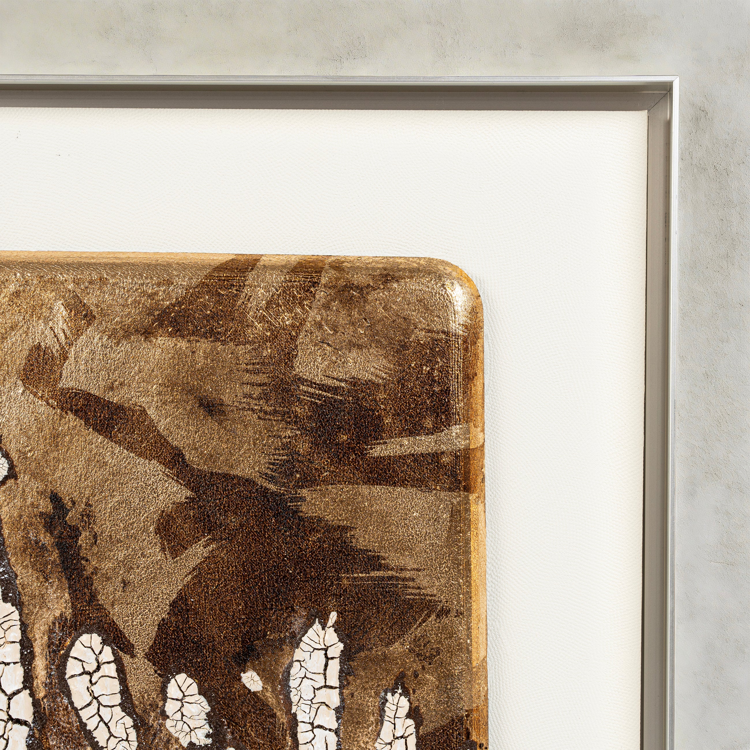 Corner detail of Efflorescence — Patinated Foil · Aura Frame, showing where heat-oxidized fired foil and flush metallic plates meet the cracked mineral ground — sixteen stages of high-temperature firing producing natural tonal variation across the metal element texture.