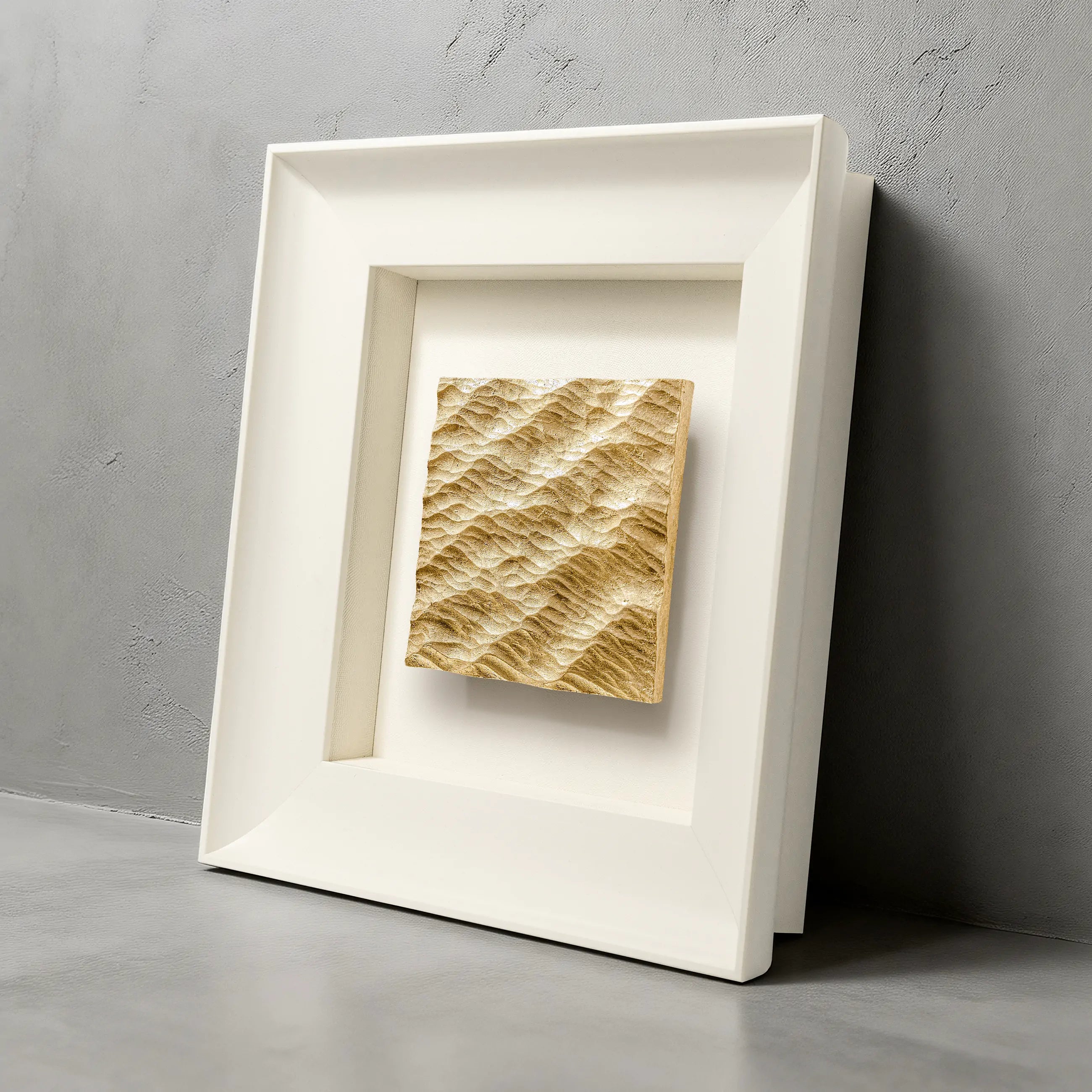 Lunar Tide — Gilded Foil · Aura Frame, full view of a water element wall art where concentric ripple relief is raised by hand across the mineral surface — each ring individually worked — and Eastern Jin Dynasty gilded foil laid into the crests, shifting warmer to receded like a tide that moves without moving.