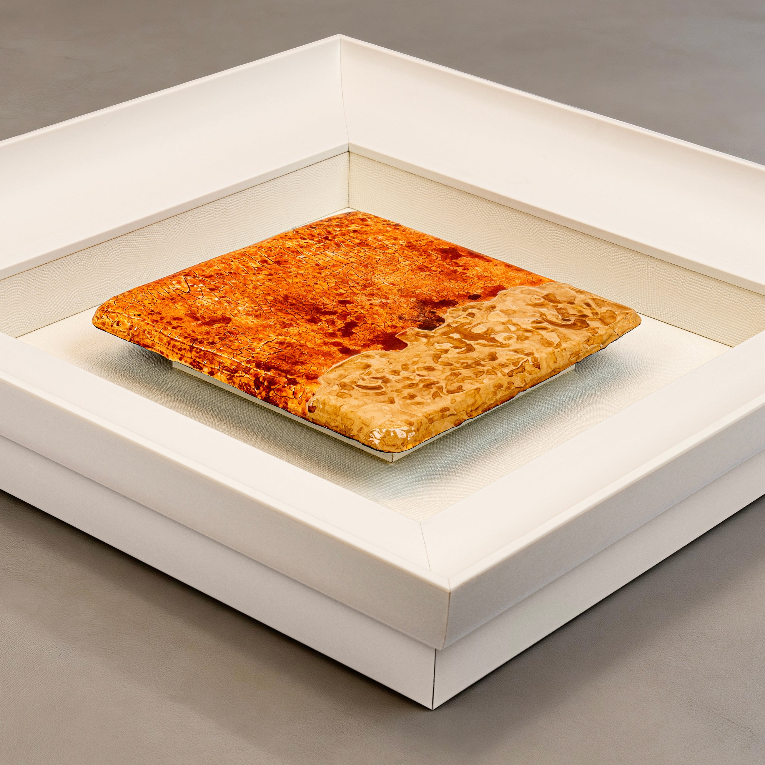 Flat-lay overhead view of Igneous — Mineral Texture · Aura Frame, capturing the full expanse of its 3D fire element mineral terrain — warm brown, ochre, and amber lava-flow texture with sandstone-rough crackle surface across every layer.