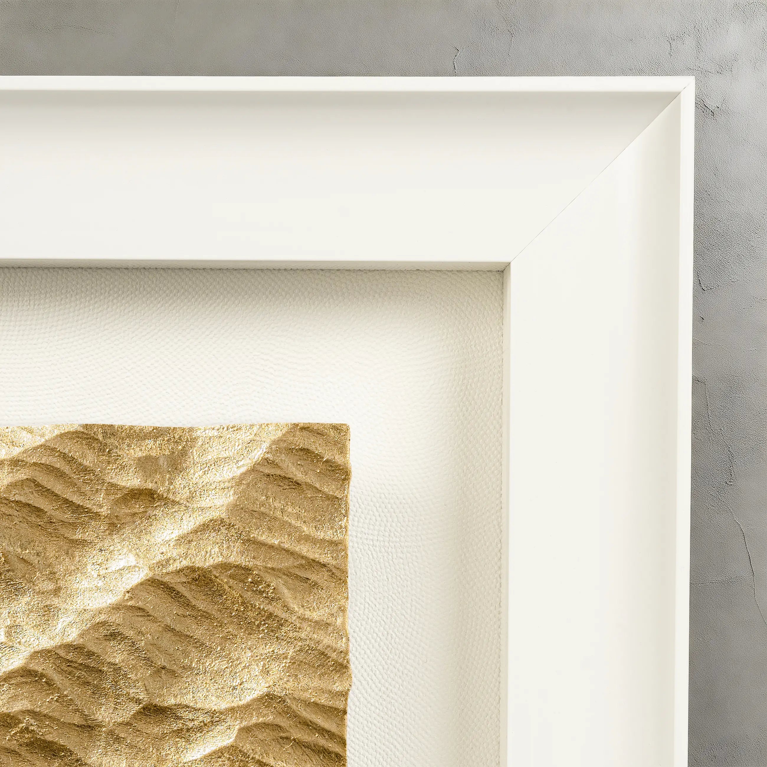 Corner detail of Lunar Tide — Gilded Foil · Aura Frame, showing the individually hand-worked concentric ripple relief of the water element mineral surface, with 0.1-micron gilded foil shifting from warm at the crests to receded in the troughs across the 3D textured terrain.