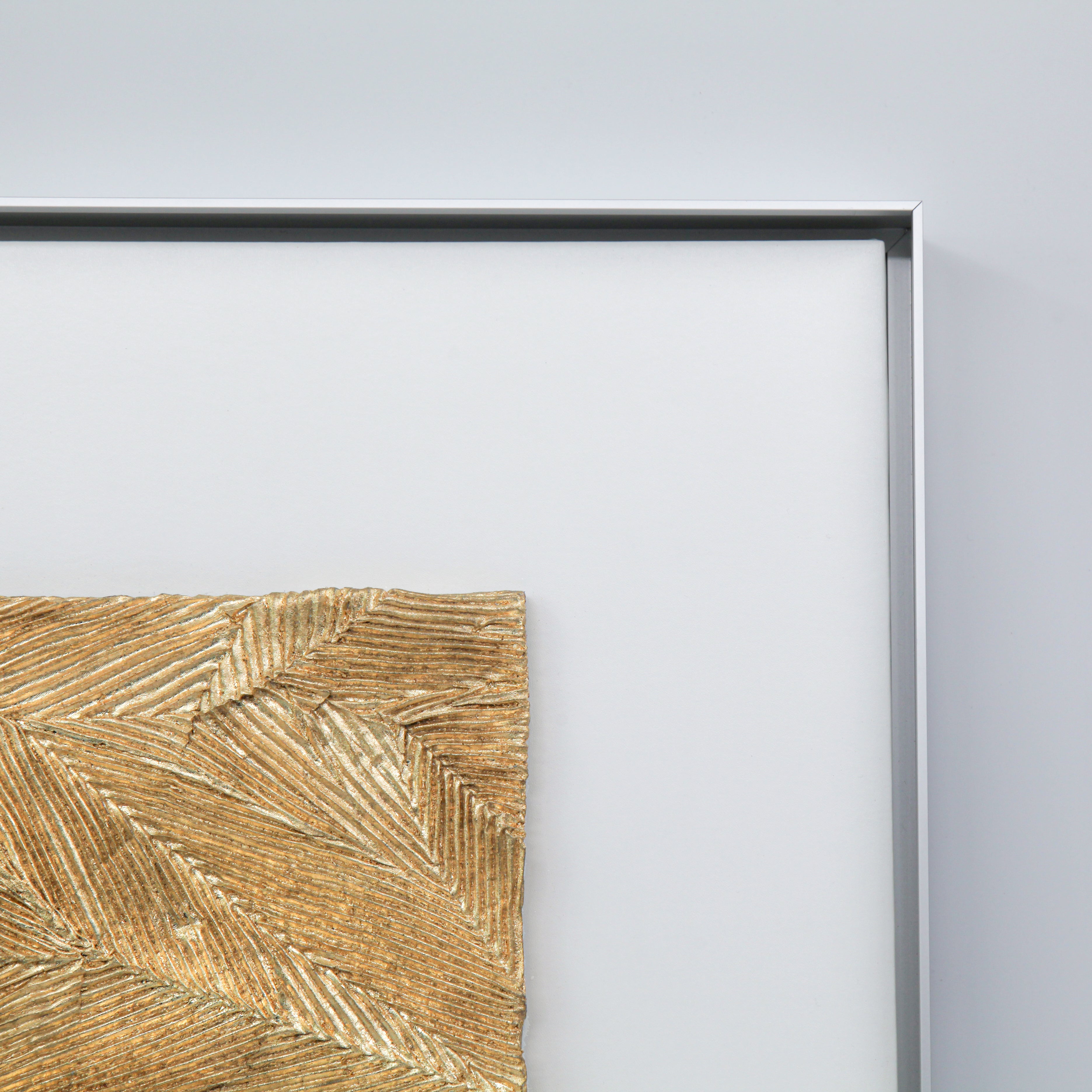 Corner detail of Meridian — Gilded Foil · Aura Frame, showing the hand-worked branching vein channels of the metal element mineral ground, with 0.1-micron gilded foil following the relief structure — luster shifting from bright to receded as light moves across the 3D textured surface.