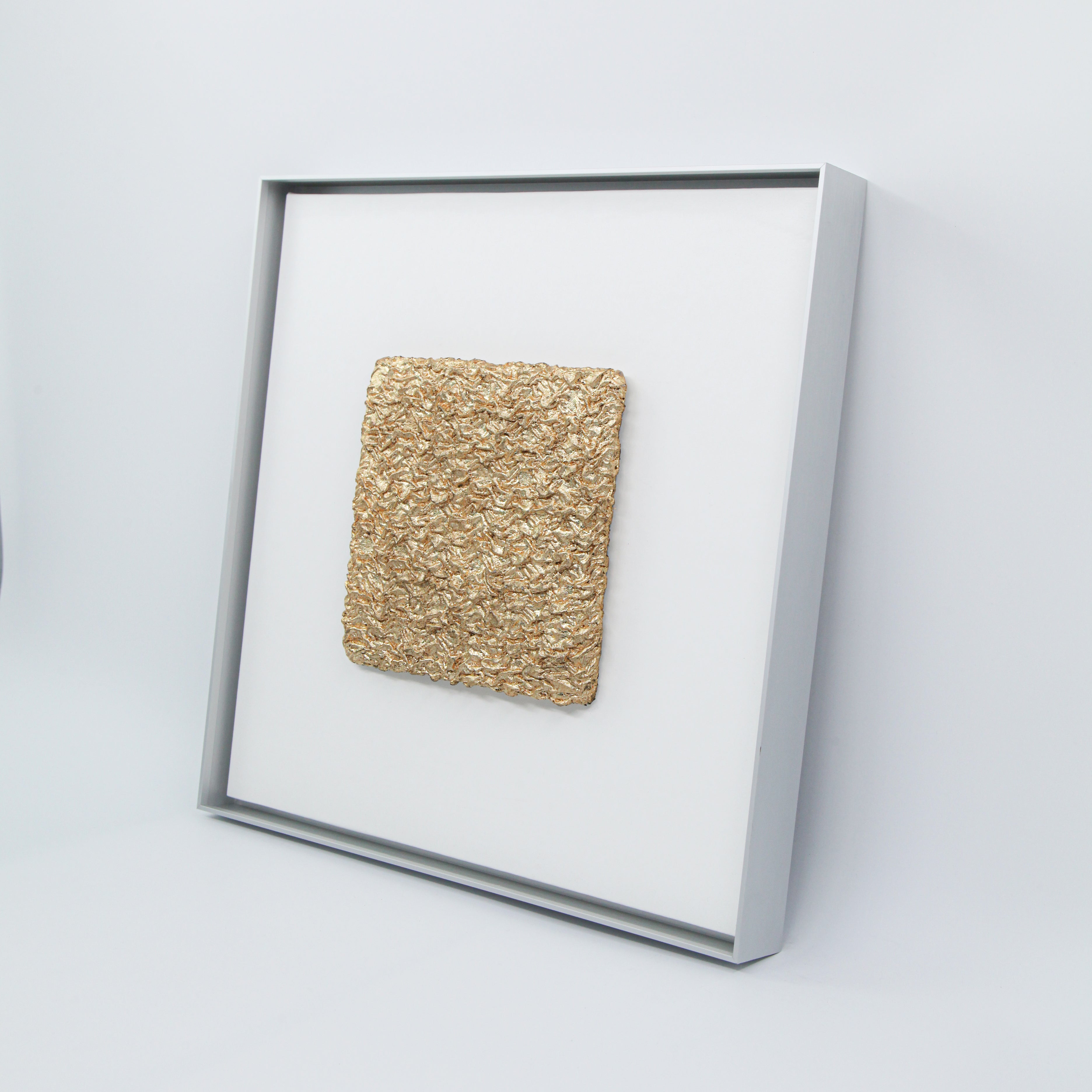 Shan — Gilded Foil · Aura Frame, full view of an earth element wall art where natural mineral pigment is hand-folded into 3D mountain ridgeline relief that reads simultaneously as cracked, desiccated earth, Eastern Jin Dynasty gilded foil surfacing from within the terrain like ore from soil.