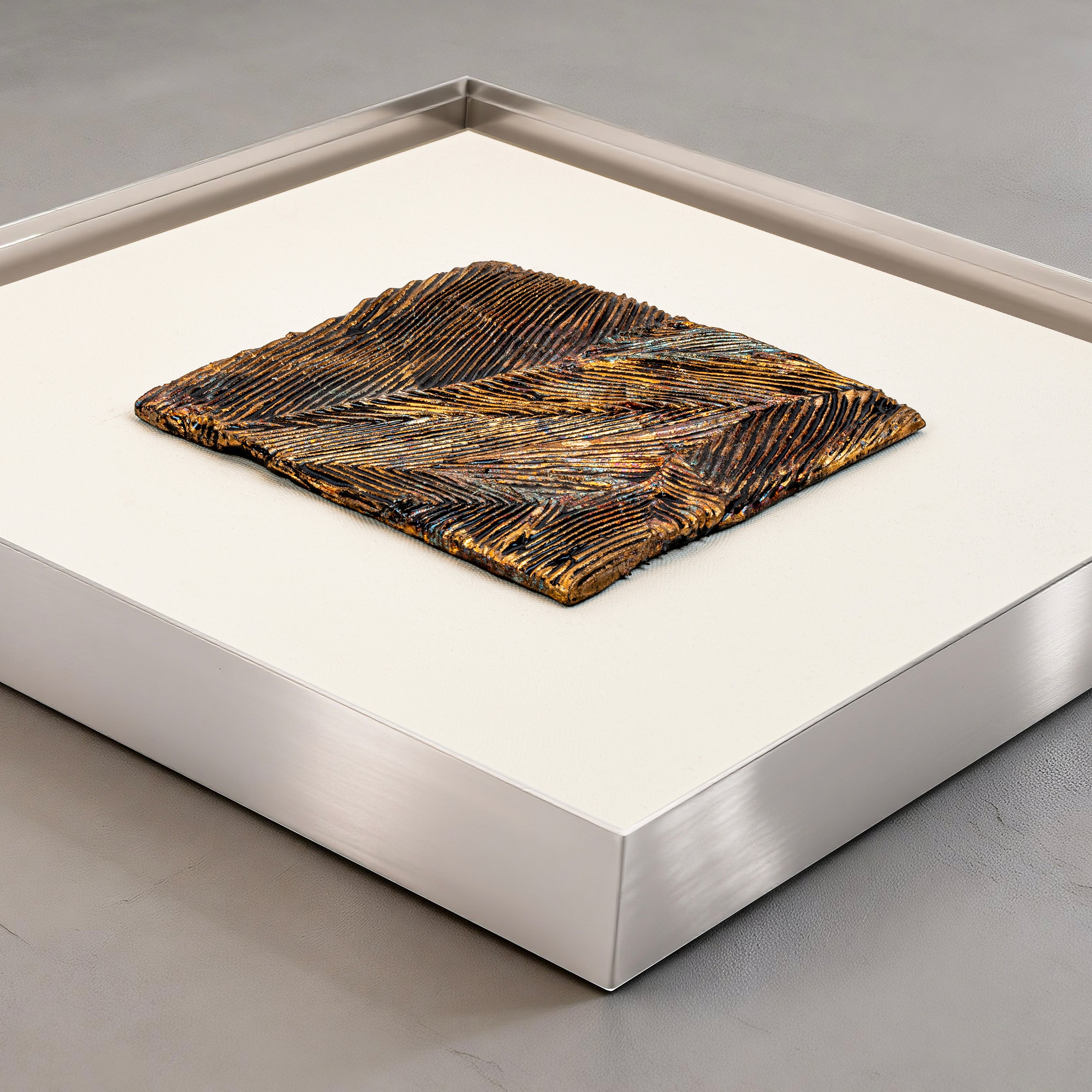 Flat-lay overhead view of Striae — Patinated Foil · Aura Frame, capturing the full expanse of its 3D metal element mineral surface — directional crackle fissures and metallic foil striations running in parallel across the rough, mottled terrain of fractured earth and fired ore.