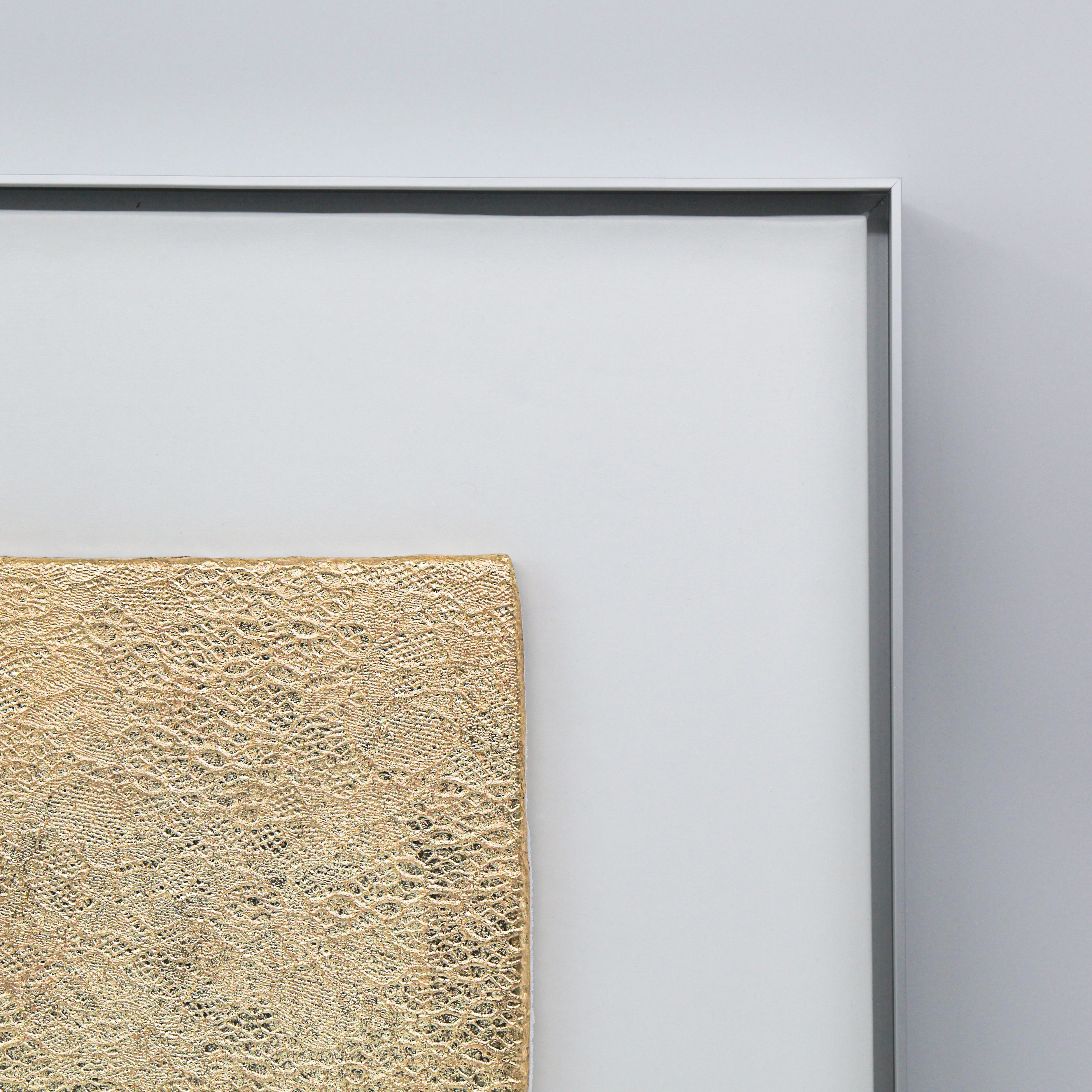 Corner detail of Tendril — Gilded Foil · Aura Frame, showing the hand-laid 0.1-micron gilded foil weaving through the wood element mineral vine relief — gold warming the green-brown tones of the 3D textured surface like sunlight filtering through a canopy at close range.